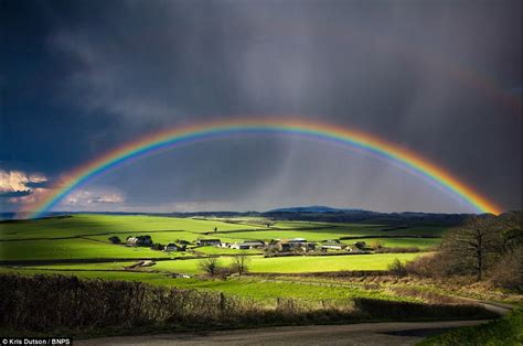 Indulge in the Transient Grandeur of Rainbows Following a Downpour